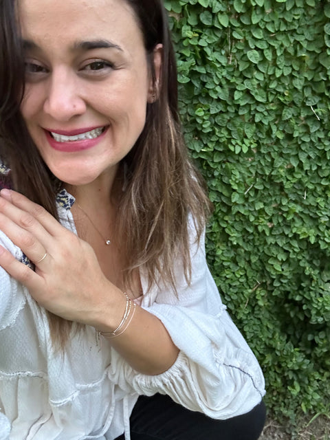 KD by an ivy wall, wearing her Morse code bracelets