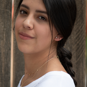 Iris CZ stud earring worn with dainty gold necklaces, side view