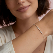 Model wearing the silver Morse code bracelet with 14k gold filled spacers
