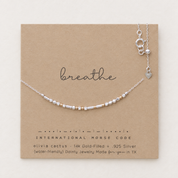 Breathe Morse code necklace in sterling silver faceted beads with 14k gold-filled accents on a dainty silver chain, shown on an Olivia Cactus card