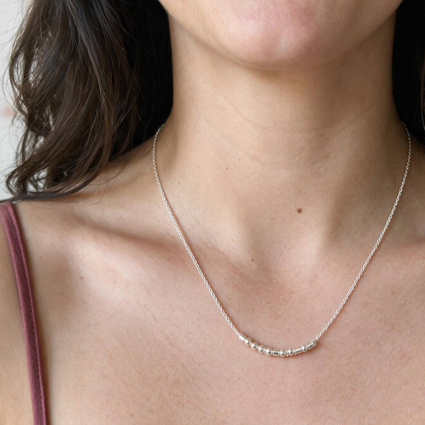 Model wearing the Extra Bold sterling silver Morse code necklace, front view