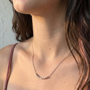 Extra Bold sterling silver Morse code necklace on a model, side view in warm sunlight