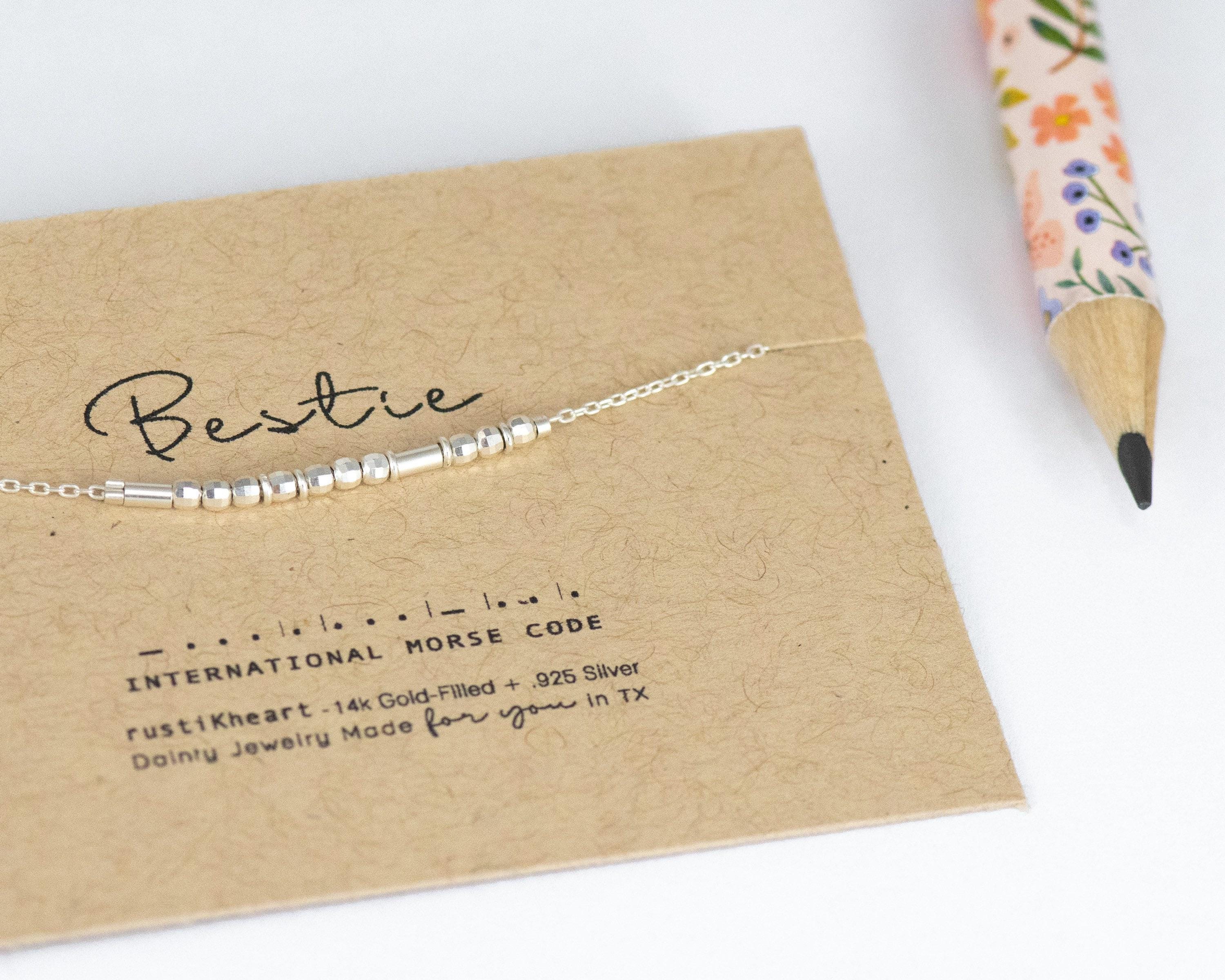 Dainty Silver Bestie Morse Code Bracelet with Tiny Silver Spacers Separating Each Letter. On Custom Printed Bestie Card Showing Morse Code.